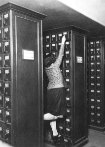 A librarian reaching for the top shelf of the card catalog. | Found on teacoffeebooks.tumblr.com